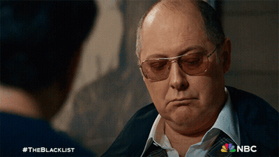 Man In Sunglasses Talking To Man With NBC Logo GIF