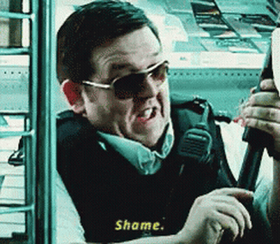 Man In Sunglasses Vest Holding Gun Saying Shame GIF
