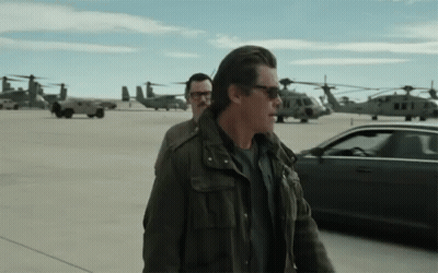Man In Sunglasses Walking Beside Man In Glasses GIF