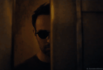 Man In Sunglasses Walking In Dark GIF