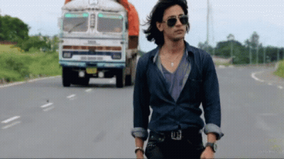 Man In Sunglasses Walking Past Tata Truck GIF