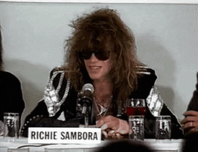 Man in Sunglasses With Richie Sambora Sign