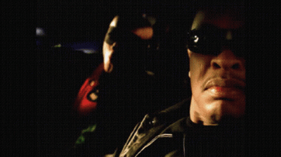 Man In Sunglasses With Woman In Green Hoodie GIF