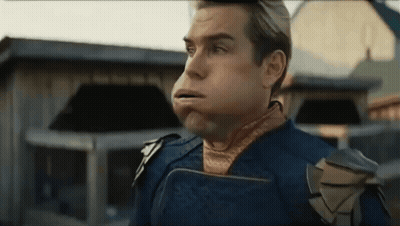 Man In Superhero Costume Blowing Bubble GIF