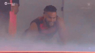 Man In Superhero Costume Flying Through Air GIF