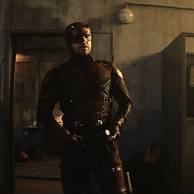 Man In Superhero Costume Holding Bat GIF