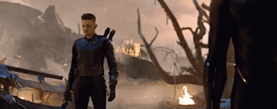 Man In Superhero Costume In Front Of Burning Building GIF