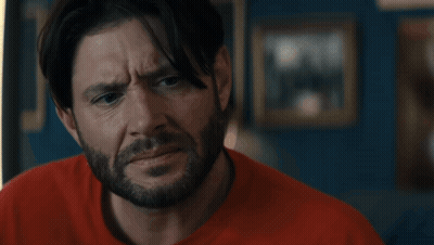 Man In Superhero Costume In Front Of Flag GIF