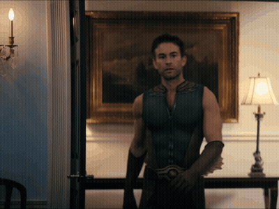 Man In Superhero Costume In Front Of Lamp GIF