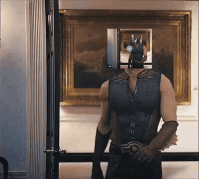 Man In Superhero Costume In Front Of Mirror GIF