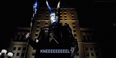 Man In Superhero Costume Kneeling In Front Of Building GIF