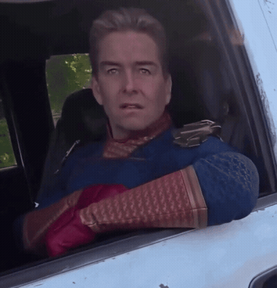 Man In Superhero Costume Looking Out Car Window GIF