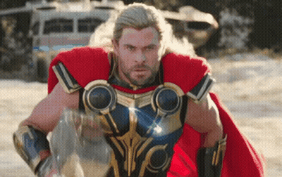 Man In Superhero Costume On Sand GIF
