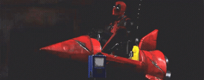 Man In Superhero Costume Riding Red Rocket GIF