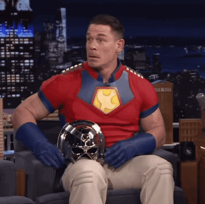 Man In Superhero Costume Sitting GIF
