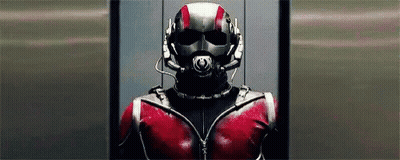 Man In Superhero Costume Standing In Elevator With Helmet GIF