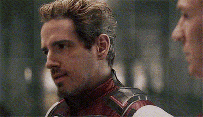 Man In Superhero Costume Talking To Another Man GIF