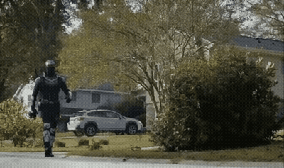 Man In Superhero Costume Walking GIF