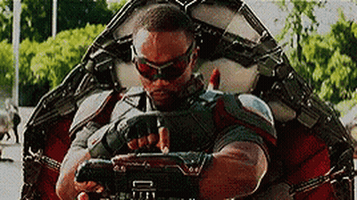 Man In Superhero Suit Holding Gun GIF