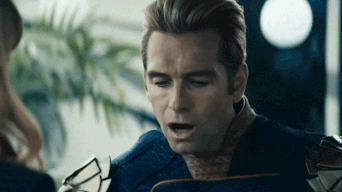 Man in Superhero Suit Talking to Woman