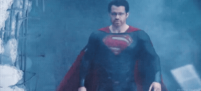 Man In Superman Costume In Dark Room GIF