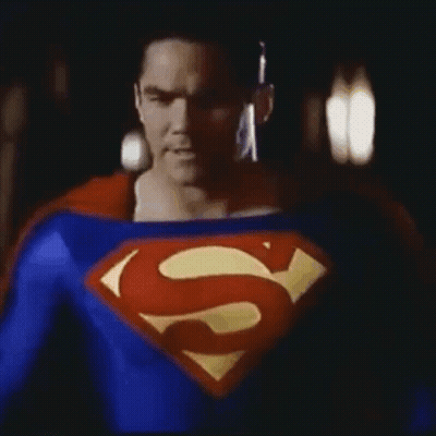 Man In Superman Costume In Dark GIF