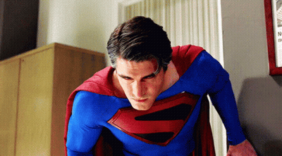 Man In Superman Costume In Front Of Wall GIF