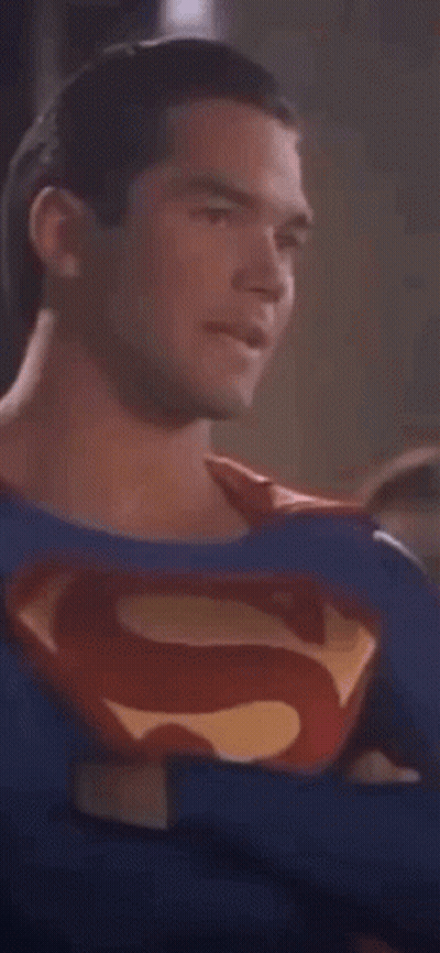 Man In Superman Costume Looking At Camera GIF