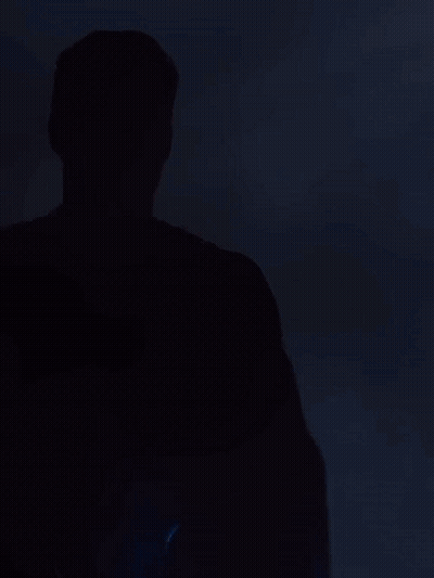 Man In Superman Costume Looking At Camera GIF