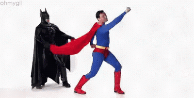 Man In Superman Costume Next To Batman GIF
