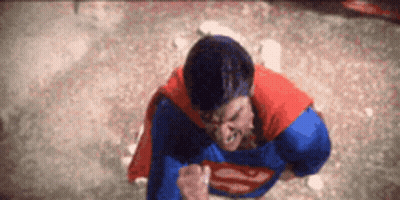 Man In Superman Costume Standing With Fist In Air GIF