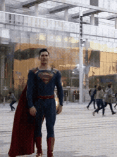 Man In Superman Costume Walking Street GIF