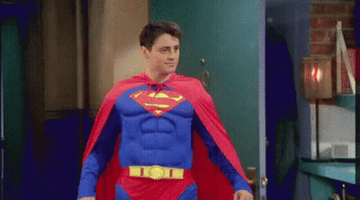 Man In Superman Costume Walking Through Doorway GIF