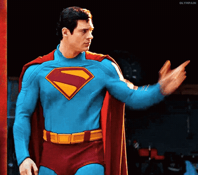 Man In Superman Costume Waving GIF