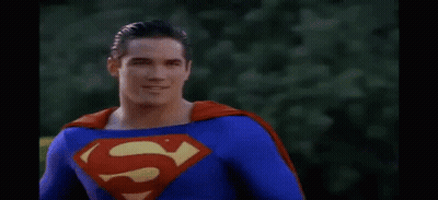 Man In Superman Costume With Red Cape Smiling GIF