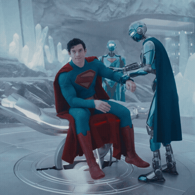Man In Superman Suit In Chair GIF