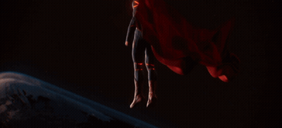 Man In Superman Suit In Front Of Planet GIF