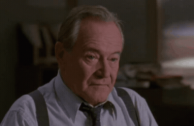 Man In Suspenders And Tie Wiping Nose GIF