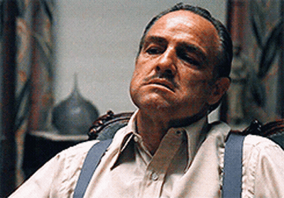 Man In Suspenders Sitting In Chair Eyes Closed GIF