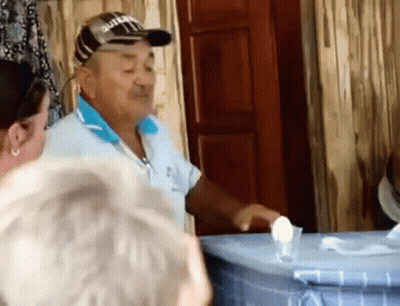 Man In Suzuki Hat Talking To Group GIF
