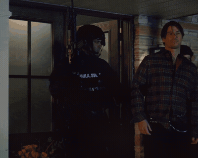 Man In SWAT Uniform In Front Of Building GIF