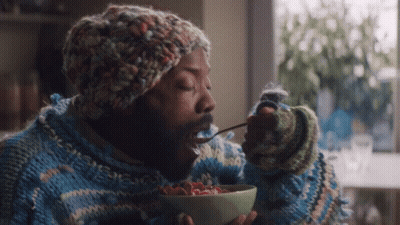 Man In Sweater And Hat Eating Cereal GIF