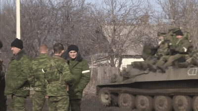 Man In Sweater And Khaki Pants Jumping GIF