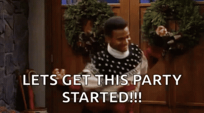 Man In Sweater At Christmas Wreath Door GIF