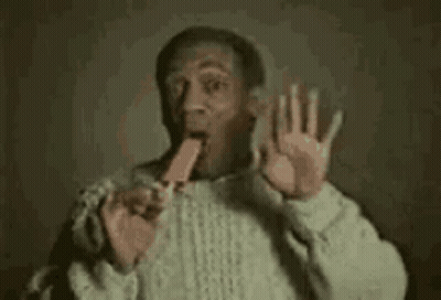 Man In Sweater Eating Popsicle Making Funny Face GIF