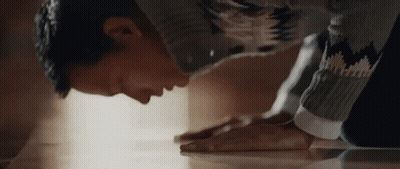 Man In Sweater Kneeling Down GIF