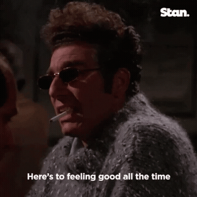 Man In Sweater Smoking Cigarette Saying Cheers GIF
