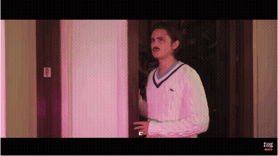 Man In Sweater Standing In Doorway GIF
