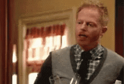 Man In Sweater Vest Holding Wine GIF