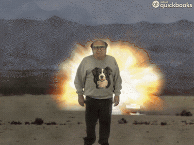 Man In Sweater With Dog Standing In Front Of Explosion GIF